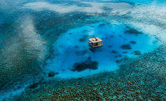 The Underwater Room at the Manta Resort is a three-level private suite with a submerged bedroom and a rooftop sundeck, anchored off the coast of Pemba Island in the Zanzibar Archipelago.