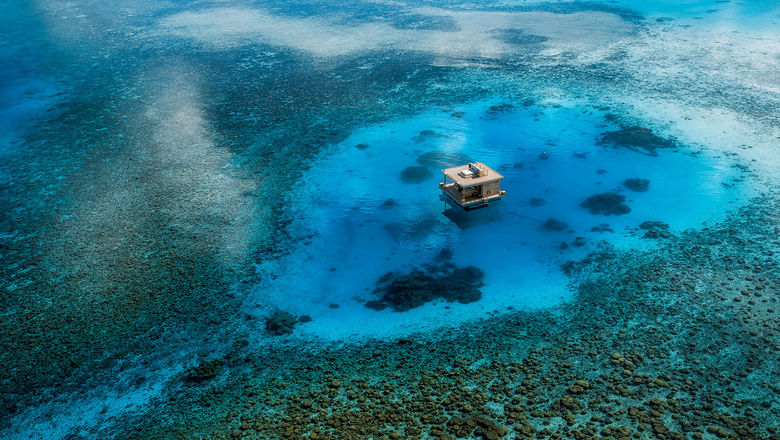The Underwater Room at the Manta Resort is a three-level private suite with a submerged bedroom and a rooftop sundeck, anchored off the coast of Pemba Island in the Zanzibar Archipelago.
