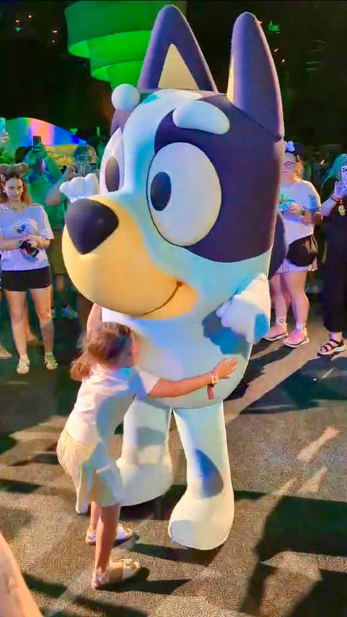 The author's daughter hugs Bluey during a preview of "Bluey's Wild World." The author's daughter hugs Bluey during a preview of "Bluey's Wild World."