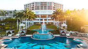 The adults-only Hibiscus Serenity Pool and fountains in front of the central tower of the resort.