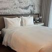 A bedroom at the Hyatt Centric Las Olas, featuring an abstract black and white mural.