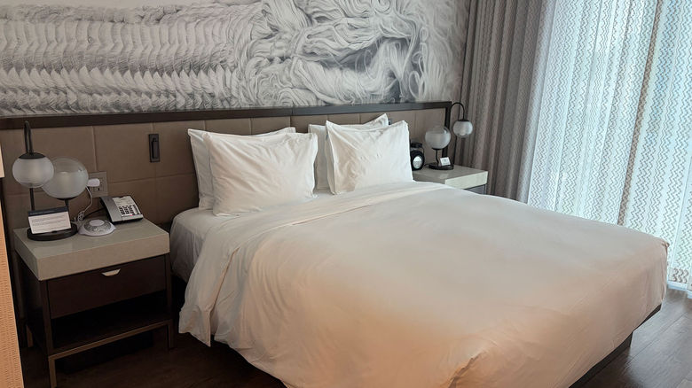 A bedroom at the Hyatt Centric Las Olas, featuring an abstract black and white mural.