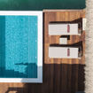 A guest relaxes at a Royalton Chic Antigua Overwater Suite.