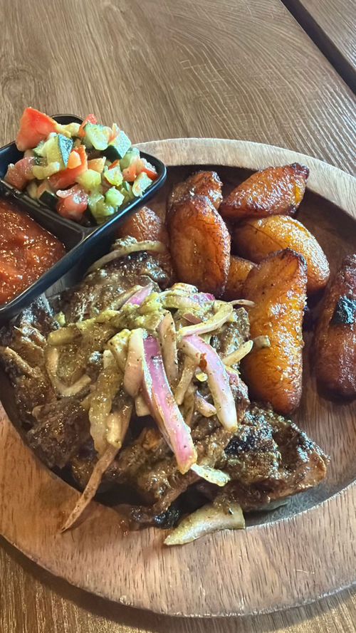 A plate of grilled lamb and sweet plantains at Les Delices de Awa A plate of grilled lamb and sweet plantains at Les Delices de Awa