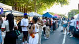 Crowds line the street as attendees browse vendor tents at the Juneteenth Food Festival at Weeksville in New York City.