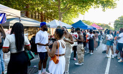 Crowds line the street as attendees browse vendor tents at the Juneteenth Food Festival at Weeksville in New York City.
