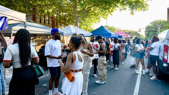 Crowds line the street as attendees browse vendor tents at the Juneteenth Food Festival at Weeksville in New York City.