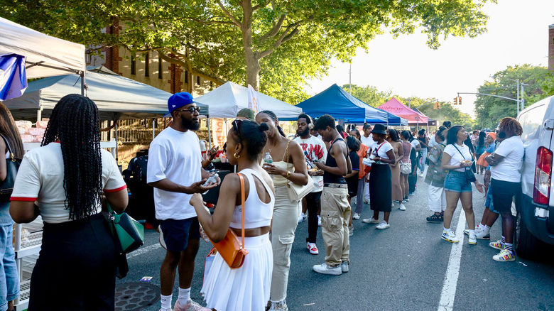 Crowds line the street as attendees browse vendor tents at the Juneteenth Food Festival at Weeksville in New York City.