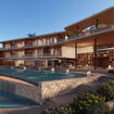 A rendering of the exterior of Ani Shoal Bay's main house and pool.