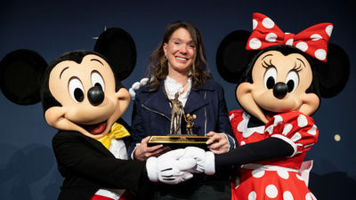 Caroline Beteta with Mickey and Minnie at her retirement dinner at Disneyland's Grand Californian Resort.