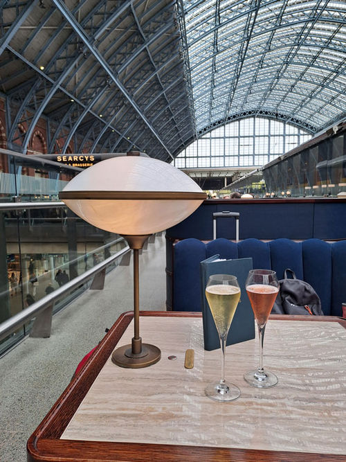 Two glasses of sparkling wine at Searcys inside St. Pancras International Station. Two glasses of sparkling wine at Searcys inside St. Pancras International Station.