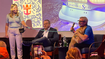 Chief dog officer Skipper and Royal Caribbean International CEO Michael Bayley embrace on the Legend of the Seas.