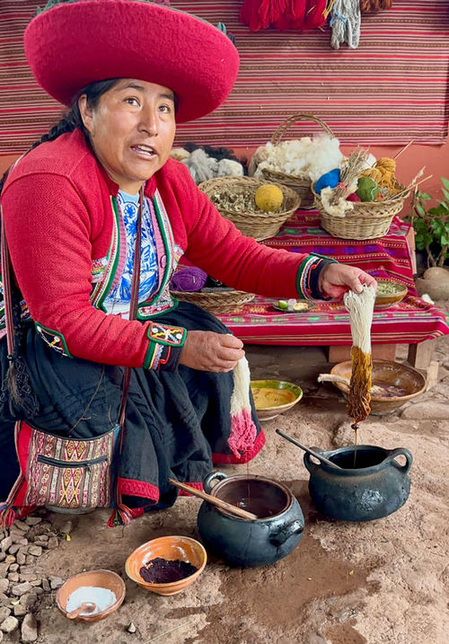 A weaver demonstrates centuries-old techniques for dyeing alpaca wool. A weaver demonstrates centuries-old techniques for dyeing alpaca wool.