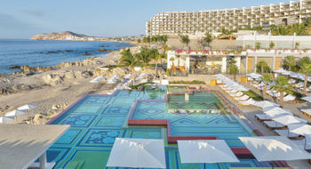 The two-level infinity pool at the Grand Velas Boutique Los Cabos overlooks the Sea of Cortes and boasts beautiful mosaic tiles of turquoise and green.