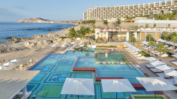The two-level infinity pool at the Grand Velas Boutique Los Cabos overlooks the Sea of Cortes and boasts beautiful mosaic tiles of turquoise and green.