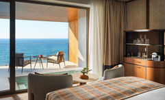 All accommodations include a private balcony with a heated pool.