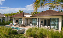 A two-bedroom oceanfront bungalow features indoor-outdoor living areas, private plunge pools and direct beach access.