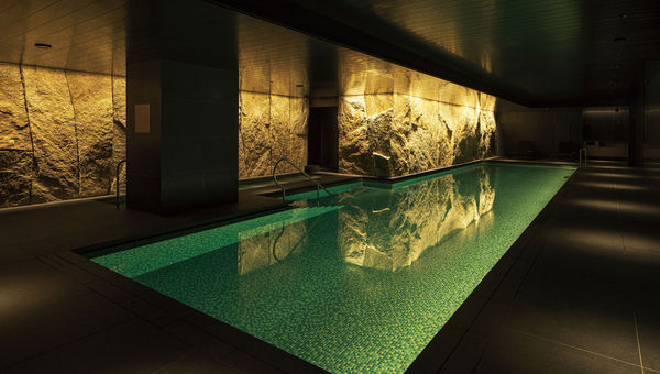Walls lined with Kitagi stone add to the atmosphere of the hotel pool. Walls lined with Kitagi stone add to the atmosphere of the hotel pool.