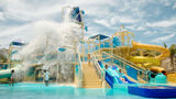Great Tides Waterpark will feature a children's splash area with multiple waterslides and water spraying from above.