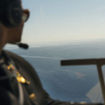 A guest looks out from a helicopter while on a Luxury Collection Expeditions experience.