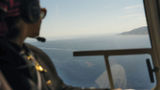A guest looks out from a helicopter while on a Luxury Collection Expeditions experience.