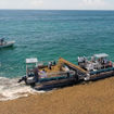 A boat collecting sargassum in Mexico before it can reach the shoreline.