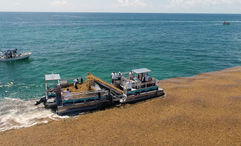A boat collecting sargassum in Mexico before it can reach the shoreline.