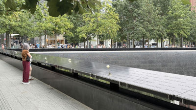 Twenty-five years after the 9/11 attacks, visitors arrive at the reflecting pools at the 9/11 Memorial & Museum that were built in the footprints of the twin towers.