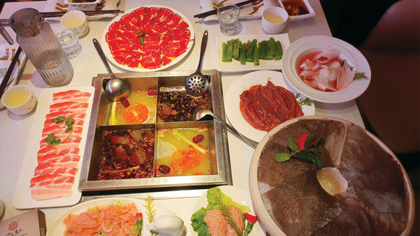 The table is set for a meal at Da Miao Hotpot in Chengdu's Kuanzhai Alley, an area of the Chinese city with a vibrant street culture.