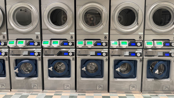 A row of washers and dryers at the Fairytale Fresh Laundry on the Disney Wish. A row of washers and dryers at the Fairytale Fresh Laundry on the Disney Wish.