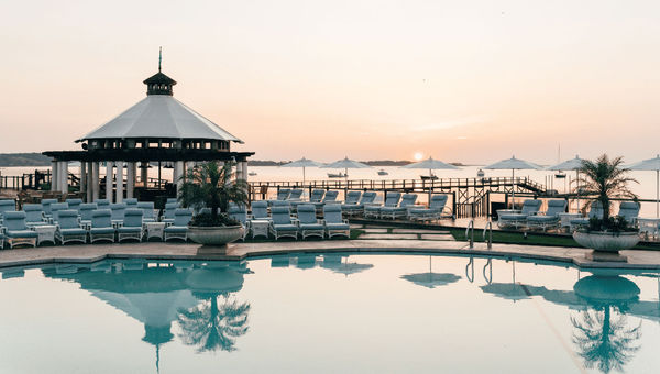 Wequassett’s main pool is flanked by luxury cabanas designed by Sister Parish, the original design firm for the Kennedy White House. Wequassett’s main pool is flanked by luxury cabanas designed by Sister Parish, the original design firm for the Kennedy White House.