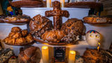 Round, sweet bread called pan de muerto is made for Dia de Muertos.