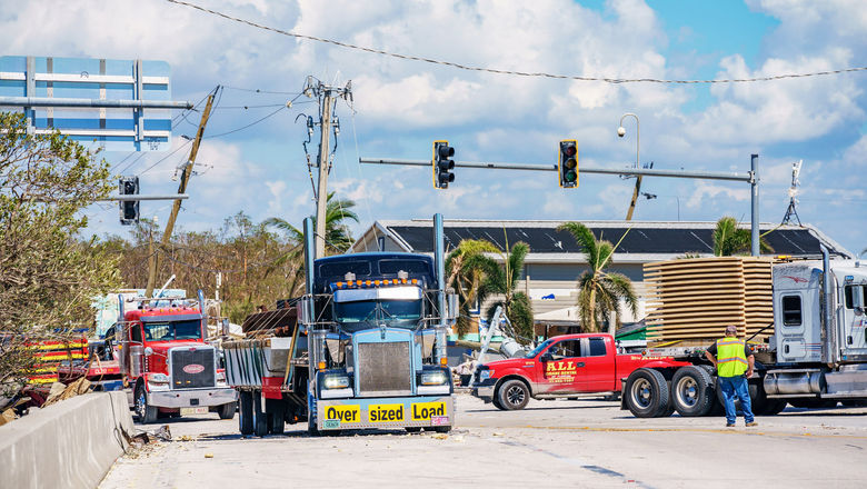 Trucks clearing debris in Fort Myers after Hurricane Ian.