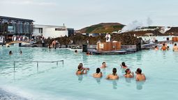 Summer tourists wading in the geothermal waters of the Blue Lagoon, one of the most popular attractions in Iceland.