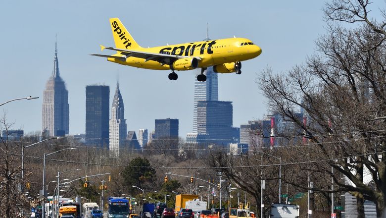 A Spirit Airlines jet approaching LaGuardia Airport.