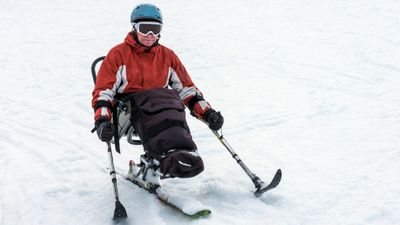 A disabled man riding a monoski.