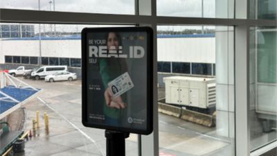 An airport billboard advertising Real IDs.