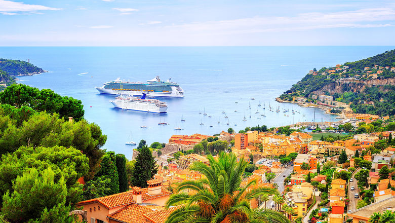 Cruise ships in the harbor at Villefranche-sur-Mer. Guests ride tender boats to the port.