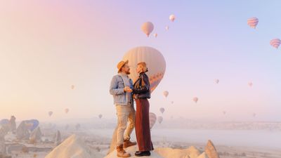 A couple in Cappadocia, Turkiye, for a hot-air balloon ride.