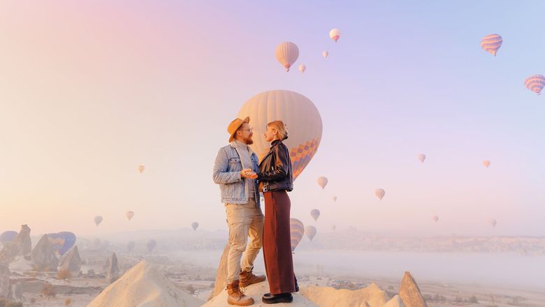 A couple in Cappadocia, Turkiye, for a hot-air balloon ride.