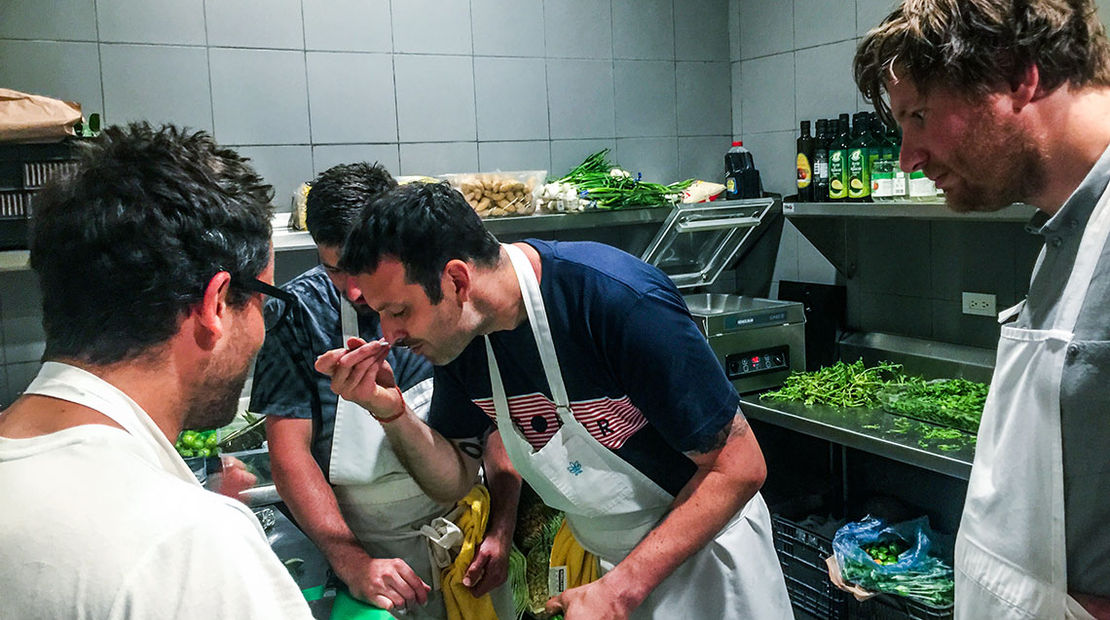 Matt Orlando, chef of Amass in Copenhagen, samples a sauce being prepared by chefs Christian Puglisi (back to camera, left) of Reloe, also in Copenhagen, and Blaine Wetzel of the Willows Inn, on Lummi Island, Wash., as Esben Holmboe Bang of Maaemo in Oslo watches.