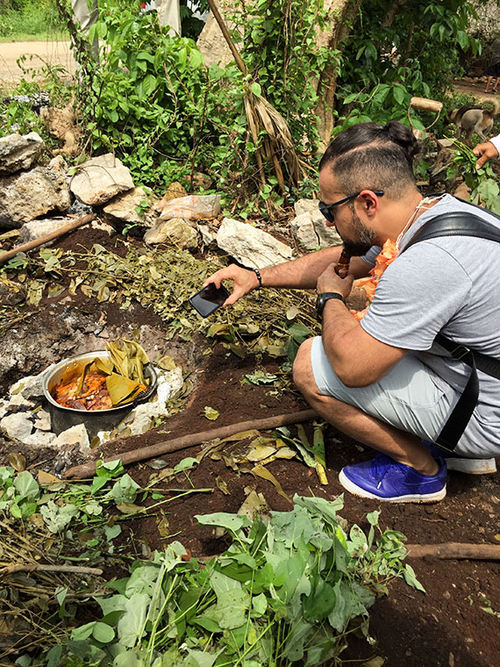 Chef Vladimir Mukhin of White Rabbit in Moscow captures the image of a pot of cochinita pibil, which contains a three month old pig, before it's pulled from its underground oven. Chef Vladimir Mukhin of White Rabbit in Moscow captures the image of a pot of cochinita pibil, which contains a three month old pig, before it's pulled from its underground oven.