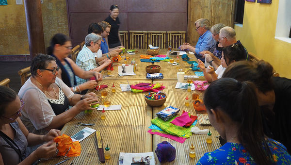 Travelers with a Vietnam National Geographic Journeys with G Adventures tour participate in a lantern making class in Hoi An, the proceeds from which go to support the not-for-profit Lifestart Foundation. Travelers with a Vietnam National Geographic Journeys with G Adventures tour participate in a lantern making class in Hoi An, the proceeds from which go to support the not-for-profit Lifestart Foundation.
