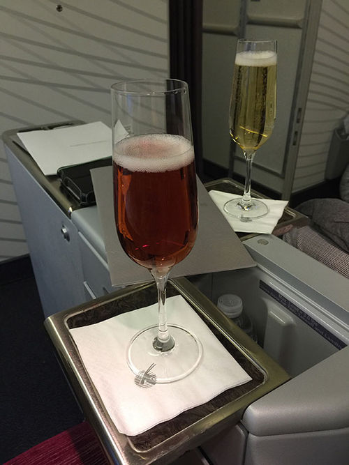 Pre-flight champagne on in the Qatar Airways business class cabin. Pre-flight champagne on in the Qatar Airways business class cabin.