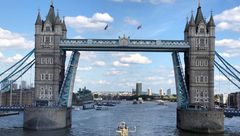 The Silver Cloud is towed aft-first through the iconic Tower Bridge in central London to start its journey to the sea along the Thames River.