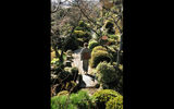 A woman strolls through a ryokan garden in Beppu, Japan.