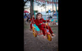 All along the Mekong, the cities and towns in Cambodia and Vietnam recall an ugly past but focus on a promising future. During a sailing aboard Uniworld's River Orchid, Mark Edward Harris caught a glimpse of that future first hand. Pictured here, a child enjoying a ride at a neighborhood amusement park in Kampong Cham, Cambodia.