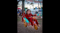 All along the Mekong, the cities and towns in Cambodia and Vietnam recall an ugly past but focus on a promising future. During a sailing aboard Uniworld's River Orchid, Mark Edward Harris caught a glimpse of that future first hand. Pictured here, a child enjoying a ride at a neighborhood amusement park in Kampong Cham, Cambodia.