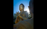Massive gilded Buddha statues at the base of the twin holy mountains of Phnom Pros and Phnom Srey (Man Hill and Woman Hill) in Kampong Cham.