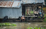 A man washes himself with the waters of the Mekong in Chau Doc.
